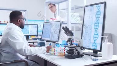 科学家在电脑前和他的助理研究细胞